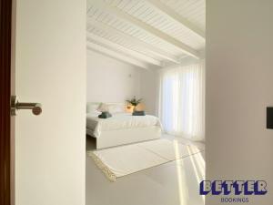 a white bedroom with a bed and a window at Alora Private Villa - Pool & 360 Mountain Views in Alora