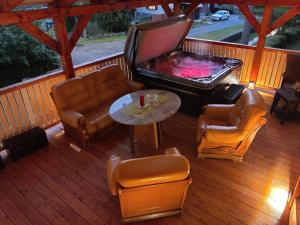 a living room with a pool table and chairs on a deck at Elements Apartments & Renata in Božičany