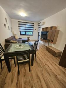 a living room with a table and a couch at Charming Apartment Borovets Gardens D16 in Samokov +13 photos