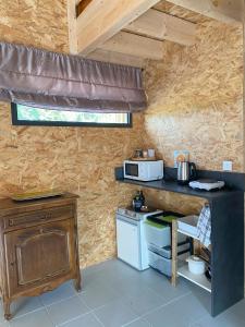 a kitchen with a stove and a counter with a microwave at Le Nid in Abbaretz