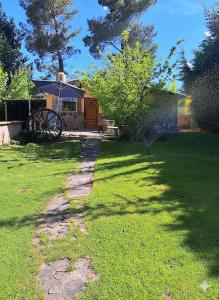 a garden with a grassy yard with an umbrella at Anto'n casa de montaña in Potrerillos