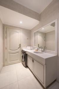 a bathroom with a sink and a washing machine at VESTA - Nile Zamalek Residence in Cairo