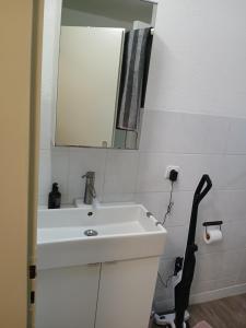 a bathroom with a white sink and a mirror at Nuri Studio in Augsburg