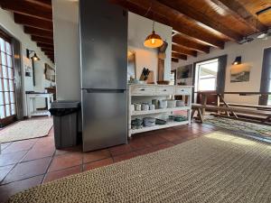 a kitchen with a stainless steel refrigerator in a room at San Ma Lou in Paternoster