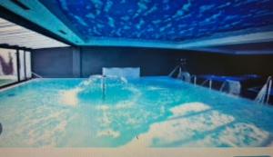 a large swimming pool with a blue ceiling at Playa, SPA, río y monte con Terraza y Parking in Orio