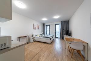 a living room with a couch and a table at Garden Towers Apartments in Prague