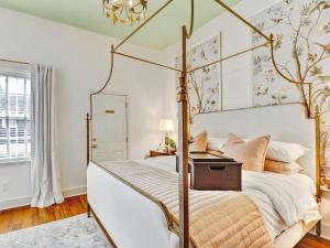 a bedroom with a four poster bed and a window at Gordon Inn Live Oak in Savannah +51 photos