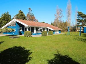 a house with a yard with a playground at 4 star holiday home in Væggerløse in Bøtø By +47 photos