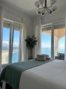 a bedroom with a bed with a view of the ocean at DDM Studio - O paraíso do Sítio da Nazaré in Nazaré