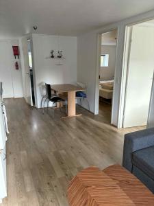 a living room with a table and a couch at Midbrekkan apartment in Tvøroyri