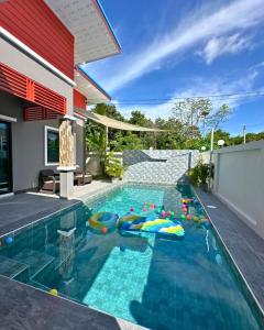 a swimming pool with inflatable balls in a house at PoolvillaLana 3 rooms in Bang Sare