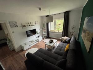 a living room with a couch and a table at Nordsee in Wilhelmshaven