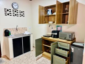 a kitchen with a sink and a microwave at Casa ao lado do Sebrae in Macapá