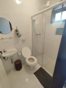a bathroom with a shower and a toilet and a sink at Casa Dos Artistas in Penedo
