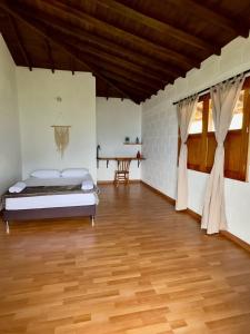 a bedroom with a bed and a wooden floor at Entre Cafetales in Jardin