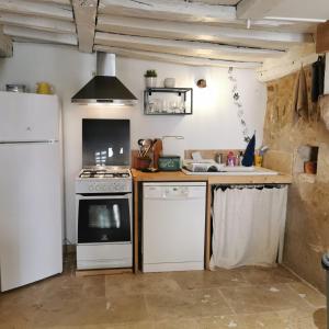 a kitchen with a stove and a refrigerator at L'échappée en Sologne in Mennetou-sur-Cher +54 photos