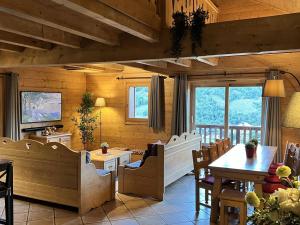 a dining room with a table and chairs at Grand appartement de 10 pers. avec piscine, spa et parking à Saint-Martin-de-Belleville - FR-1-461-7 in Saint-Martin-de-Belleville