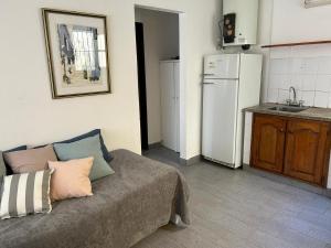 un salon avec un canapé et une cuisine dans l'établissement Departamento Centrico, à Tandil
