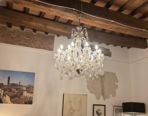 a chandelier hanging from a ceiling in a room at Le Dimore della Seta in Lucca +16 photos