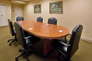 a conference room with a wooden table and chairs at Holiday Inn Express Hotel & Suites Drums-Hazelton by IHG in Drums