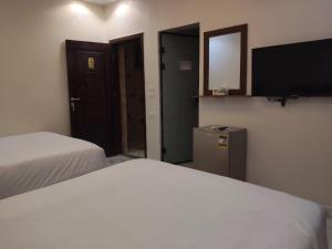 Postel nebo postele na pokoji v ubytování NEMES Pyramids View INN + 32 fotografií