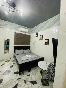 a small room with a bed and a table at CASA Sapphira Transient House in Santo Tomas