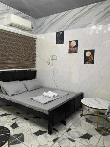 a room with a bed and a table at CASA Sapphira Transient House in Santo Tomas