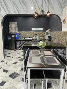 a kitchen with a table and a counter top at CASA Sapphira Transient House in Santo Tomas
