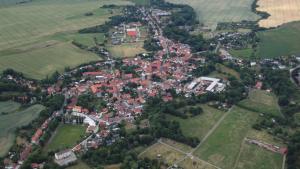 an aerial view of a town with houses and trees at Ferienhof Meisdorf - Brückenwohnung in Meisdorf +2 photos