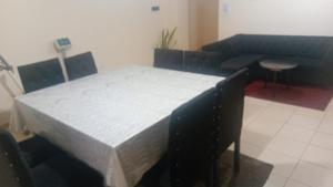 a large bed in a room with two blue benches at Departamento CNH pleno centro SGO CAPITAL in Santiago del Estero