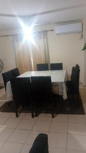 a table and chairs in a room with a light at Departamento CNH pleno centro SGO CAPITAL in Santiago del Estero