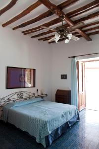 a bedroom with a bed and a television on the wall at Hotel Cincotta in Panarea