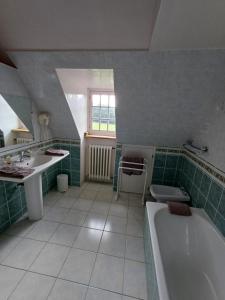 a bathroom with a tub and a sink and a bath tub at Manoir Du Stang in La Forêt-Fouesnant +85 photos