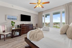 a bedroom with a large bed with a ceiling fan at Laketown Wharf 933 in Panama City Beach