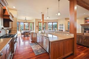a large kitchen with wooden cabinets and a large island at Drake Park Villa in Bend