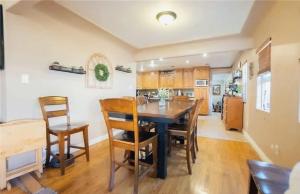 a kitchen and dining room with a table and chairs at Three Bedroom Home with Guest Suite in San Pedro Peninsula Hospital Heliport