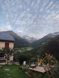 a view of a mountain range with a table and chairs at Cabane Perce Neige - Gavarnie in Gèdre