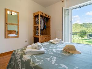 a bedroom with two beds with towels and a window at Podere Limeria Country Home nelle Marche in Fermignano