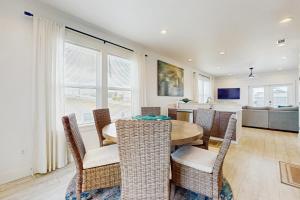 a dining room with a table and chairs at Cactus Cove Hangout in Gulf Shores