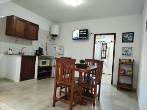 a kitchen with a table and two chairs in it at La Plaza in Formosa