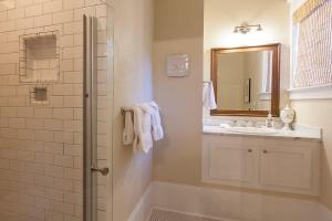 a bathroom with a sink and a shower with a mirror at Cascade Chic 30 day minimum in Hood River +17 photos