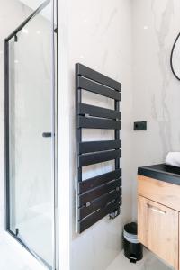 a bathroom with a shower and a sink at Le Chenavard IV-Coeur Lyon-Central air conditioning in La Celle-sous-Gouzon