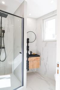 a bathroom with a shower with a glass door at Le Chenavard IV-Coeur Lyon-Central air conditioning in La Celle-sous-Gouzon