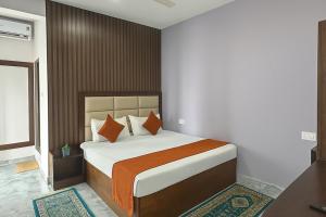 Ένα ή περισσότερα κρεβάτια σε δωμάτιο στο Akshata Residency at Goa