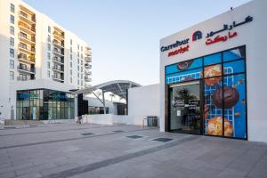 a building with a sign on the side of it at Seabreeze Studio Yas Island in Abu Dhabi