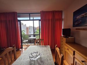 a dining room with a table and a view of a balcony at Miel de Guarapo Apartment in La Gomera