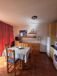 a kitchen and dining room with a table and chairs at Miel de Guarapo Apartment  +8 photos