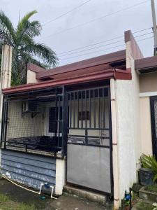 a house with a large door in the front of it at CASA Sapphira Transient House in Santo Tomas