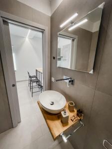 a bathroom with a white sink and a mirror at NAMA STAY Bed and breakfast in Adelfia