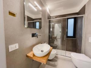 a bathroom with a sink and a toilet and a shower at NAMA STAY Bed and breakfast in Adelfia +42 photos